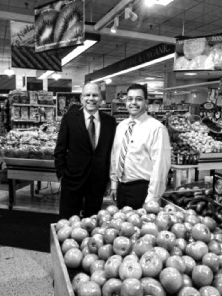 Scott Laurans, left, and Brian Pacheco in the produce department of the Eastside Marketplace.